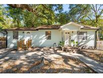 Light teal house with wooden steps and a spacious yard at 10 Paula Dr, Charleston, SC 29407