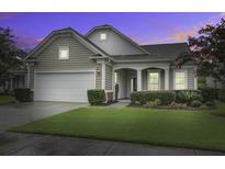 Charming craftsman style home with a two-car garage and manicured lawn at 104 Schooner Bend Ave, Summerville, SC 29486