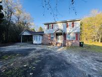 Brick home with carport and large yard at 144 Butterfly Ln, Moncks Corner, SC 29461