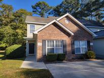 Brick and vinyl siding townhouse with a well-maintained lawn at 4743 Skillmaster Ct, North Charleston, SC 29418