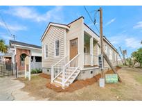 Newly renovated craftsman home featuring a welcoming front porch and charming facade at 194 Nassau St, Charleston, SC 29403