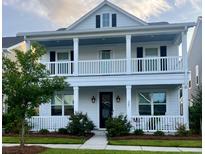 Two-story home with white siding, front porch, and landscaping at 205 Oak View Way, Summerville, SC 29483