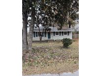 Ranch style home with green shutters and a spacious yard at 206 Palmetto St, Moncks Corner, SC 29461