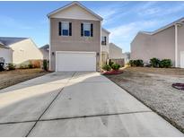 Two-story house with attached garage and landscaped yard at 140 Stoney Creek Way, Moncks Corner, SC 29461