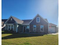 Two-story craftsman style home with stone accents and a landscaped lawn at 219 Darby Meadow Ln, Ridgeville, SC 29472