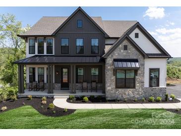 Stunning two-story home with stone accents and a metal roof at Lot 320 Waterton Trl # Hawthorne, Belmont, NC 28012