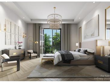 Luxurious primary bedroom with balcony access and stylish decor at 409 Queens Rd # 401, Charlotte, NC 28207