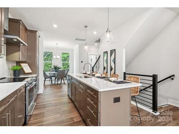 Modern kitchen with island and stainless steel appliances at 1424 Hamilton St # 12, Charlotte, NC 28206