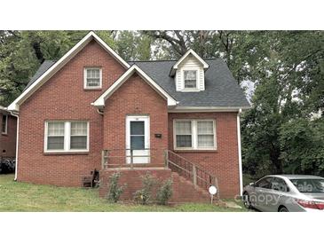 Brick ranch home with steps leading to the front door at 712 Tennyson Dr, Charlotte, NC 28208