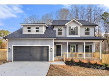 Two-story house with gray siding, gray garage door, and porch at 1975 Ripplerock Rd, Fort Mill, SC 29715