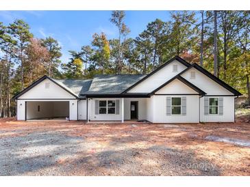 White house with gray shutters, dark gray roof, and a two-car garage at 6172 Lowder Rd, Salisbury, NC 28147