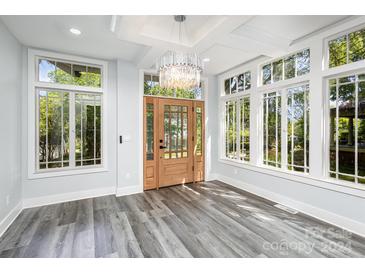 Bright entryway with hardwood floors, a statement chandelier, and sun-filled windows at 423 W Bell St, Statesville, NC 28677