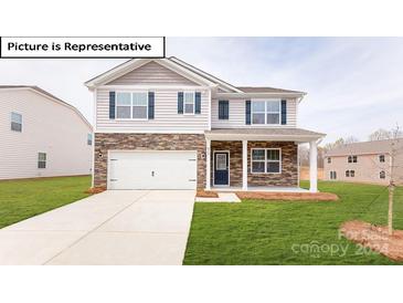 Two story home with stone and siding exterior at 7765 Woolsey Dr, Gastonia, NC 28056