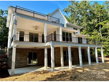 Two-story home with large deck and brick foundation at 416 Plantation Way, Mount Gilead, NC 27306