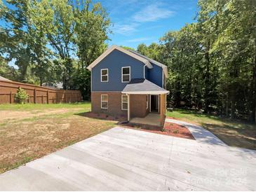 Newly built home with blue siding and a concrete driveway at 48 Magnolia St, York, SC 29745