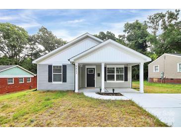 Charming craftsman style home with gray siding and a covered porch at 744 Wyoming Nw Dr, Concord, NC 28027