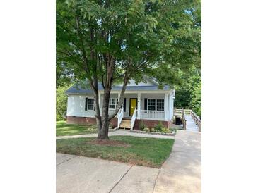 One-story home with yellow door and covered porch at 13 Cascade St, Mooresville, NC 28115