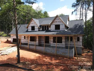 Under construction home with large footprint and gray roof at 300 Spanish Oak Ln, Gastonia, NC 28056