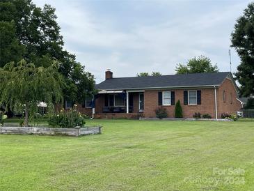 Brick ranch house with landscaped yard at 202 Division Ave, Rockwell, NC 28138