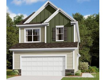 Two-story home with attractive green and beige siding at 2746 Yeager Nw Dr, Concord, NC 28027