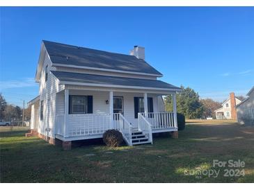 White house with front porch and yard at 2120 Walden Rd, Lancaster, SC 29720