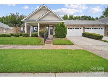 Brick ranch home with a two-car garage and porch at 6710 Cinnamon Cir, Mint Hill, NC 28227