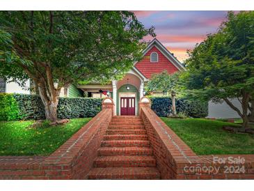 Brick stairs leading to charming red and green two-story home at 8244 Dumphries Dr, Huntersville, NC 28078