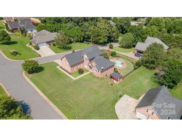 Aerial view of a house with a pool and large backyard in a quiet neighborhood at 3806 Steve Ikerd Ne Dr, Hickory, NC 28601