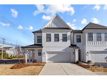 Modern white two-story home with attached garage and driveway at 6007 Mariemont Cir # 101, Charlotte, NC 28226