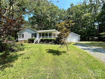 House exterior with attached garage and large yard at 2232 Stallings Rd, Matthews, NC 28104