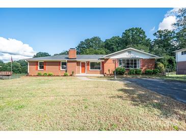 Brick ranch home with red shutters, landscaping, and driveway at 511 Villa St, Kannapolis, NC 28083