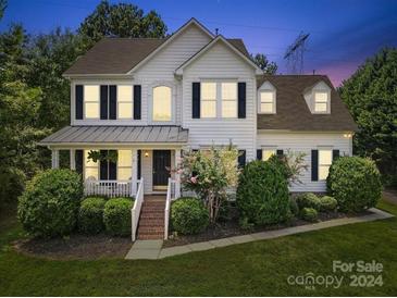 Two-story home with white siding and charming front porch at 1900 Mt Isle Harbor Dr, Charlotte, NC 28214