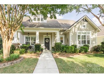 Tan house with front porch and landscaped yard at 569 Channel Rd, Clover, SC 29710