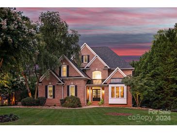 Brick house with two-car garage and manicured lawn at 21420 Blakely Shores Dr, Cornelius, NC 28031