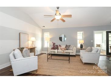 Bright living room features hardwood floors, comfy seating, and a stylish coffee table at 12321 Hortulan Ct, Huntersville, NC 28078