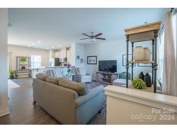 Open living room with kitchen view, sectional sofa and armchairs at 5013 Patton Dr, Gastonia, NC 28056