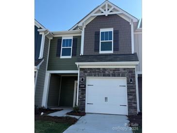 Two-story house with a modern design, featuring a two-car garage and stone accents at 3558 Nimbell Rd, Monroe, NC 28110