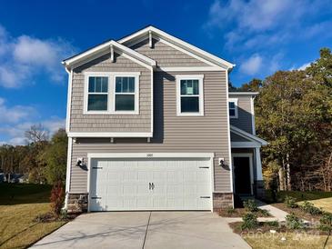 Two-story house with gray siding, white garage door, and landscaping at 1005 Freeman View Dr, Albemarle, NC 28001