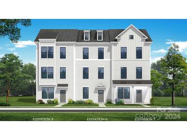 Three-story townhome with gray siding and dark roof at 15309 Ballancroft Pkwy # 34, Charlotte, NC 28277