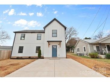 Two-story home with white siding, blue door, and a spacious front yard at 103 Apricot St, Belmont, NC 28012