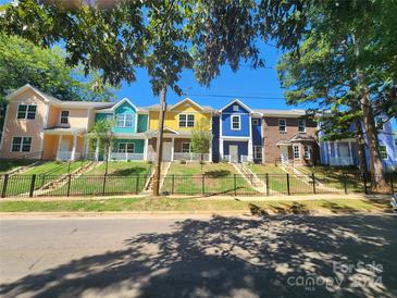 Row of colorful townhouses with black fences at 2115 Madrid St, Charlotte, NC 28216