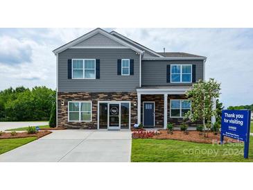 Two story home with gray siding and stone accents at 3898 Maxwell Henry Nw Ln, Conover, NC 28613