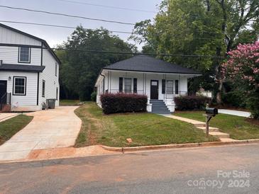 Charming white house with a well-manicured lawn at 306 Sacco St, Belmont, NC 28012