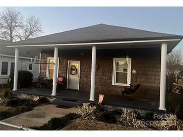 Charming home exterior with a covered porch and mature trees at 84 Walnut Ave, Gastonia, NC 28054