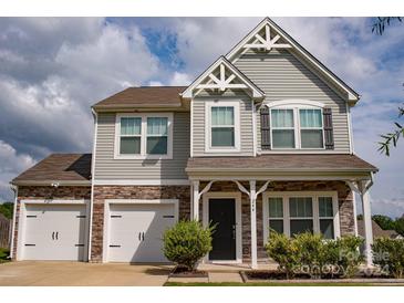 Two-story house with gray siding, stone accents, and a two-car garage at 244 Austen Lakes Dr # 100, York, SC 29745