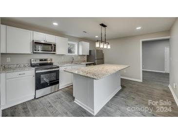 Modern kitchen with granite island and stainless steel appliances at 314 S Government St, Lincolnton, NC 28092