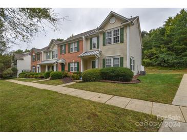 Brick front townhouses with green shutters and landscaping at 12431 Jessica Pl, Charlotte, NC 28269