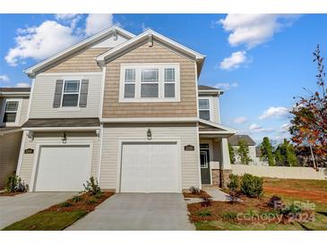 Two-story townhome with neutral siding, two-car garage, and landscaping at 2355 Hedgecliff Rd # 16, Kannapolis, NC 28083