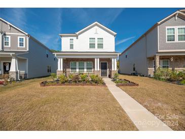 Two-story home with brick and siding, landscaped front yard at 446 Cranford Dr, Pineville, NC 28134