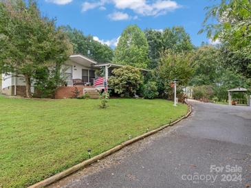 Ranch-style home with carport and landscaped yard at 7676 Shoupes Grove Church Rd, Hickory, NC 28612